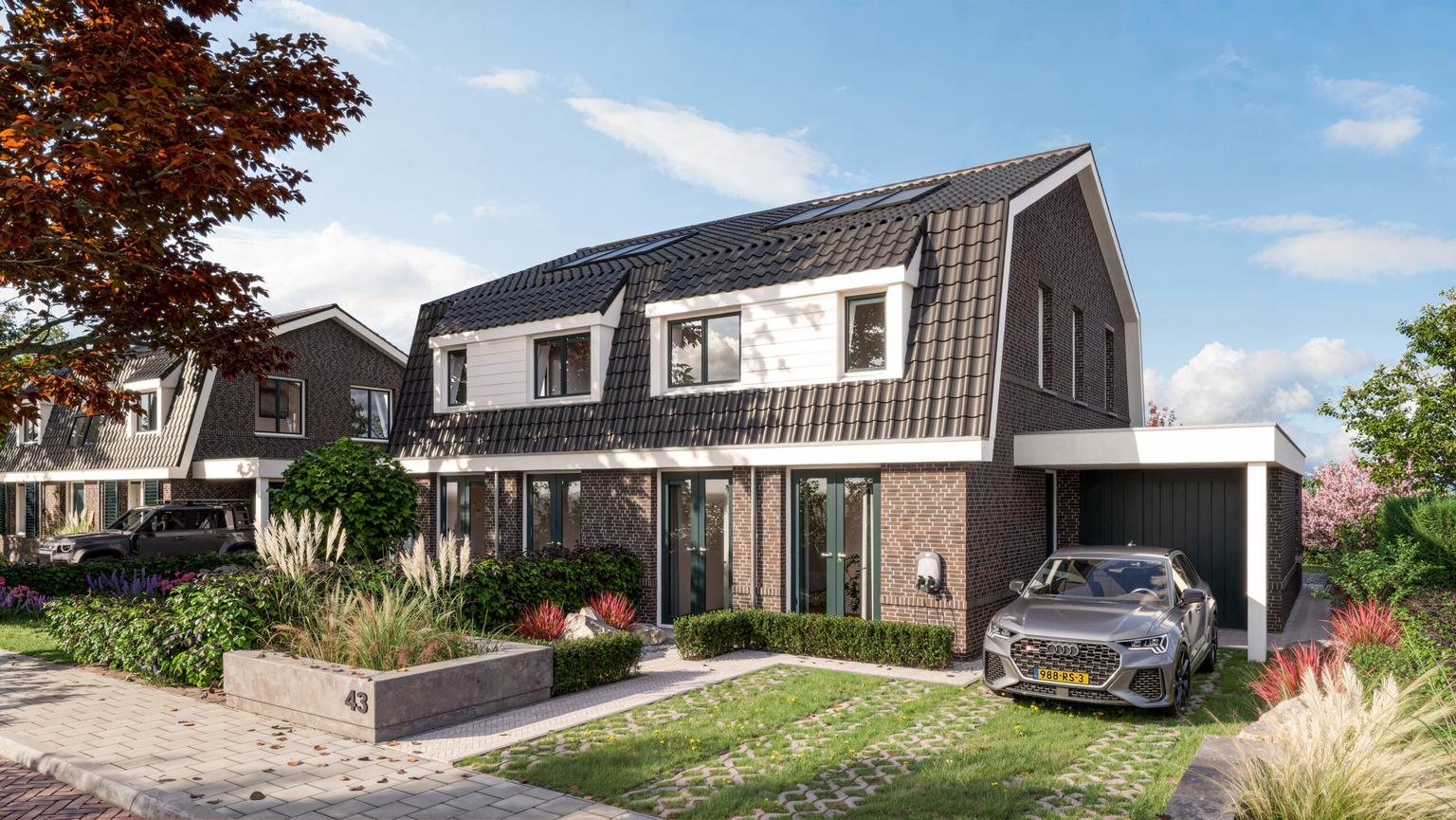 Voorzijde van moderne twee onder een kap woning met oprit